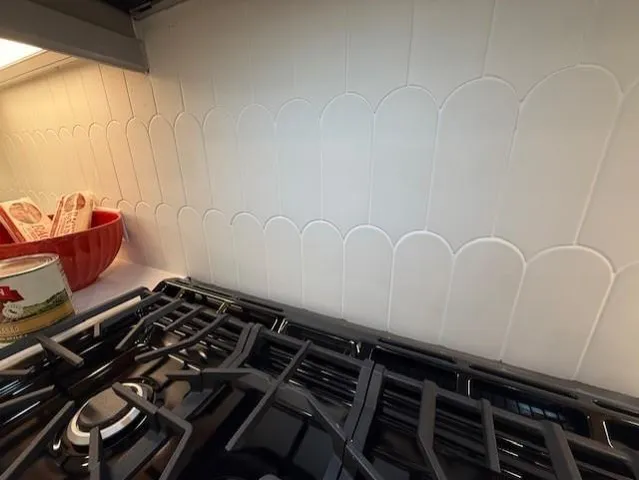 a large kitchen with kitchen island a sink a center island stainless steel appliances and a cabinets