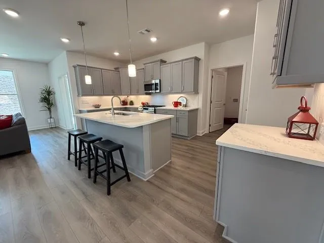 a living room with furniture ceiling fan and a window