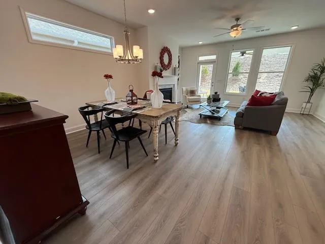 a view of a dining room with furniture a chandelier and wooden floor