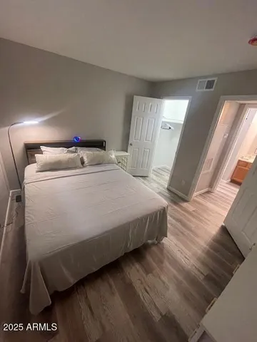 a bedroom with a bed and a mirror