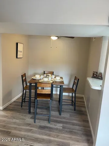 a dining room with furniture and wooden floor