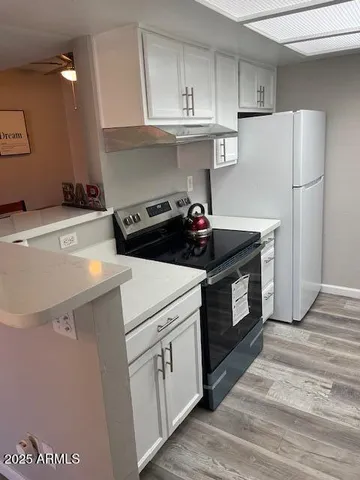 a kitchen with a stove and a refrigerator