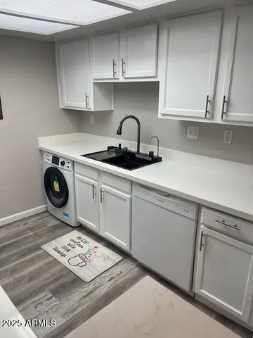 a close view of a sink and cabinets in a kitchen