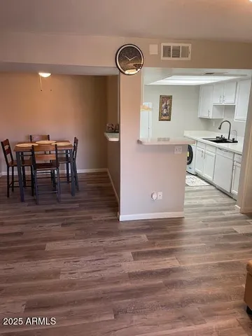 a view of kitchen with cabinets and wooden floor