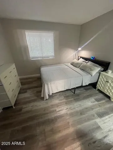 a bedroom with a bed and window