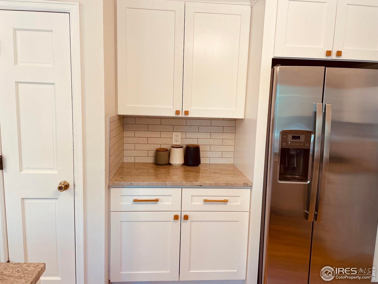 4303 30th Street Boulder, CO 80301 - Photo 14 of 37 a kitchen with a refrigerator and cabinets