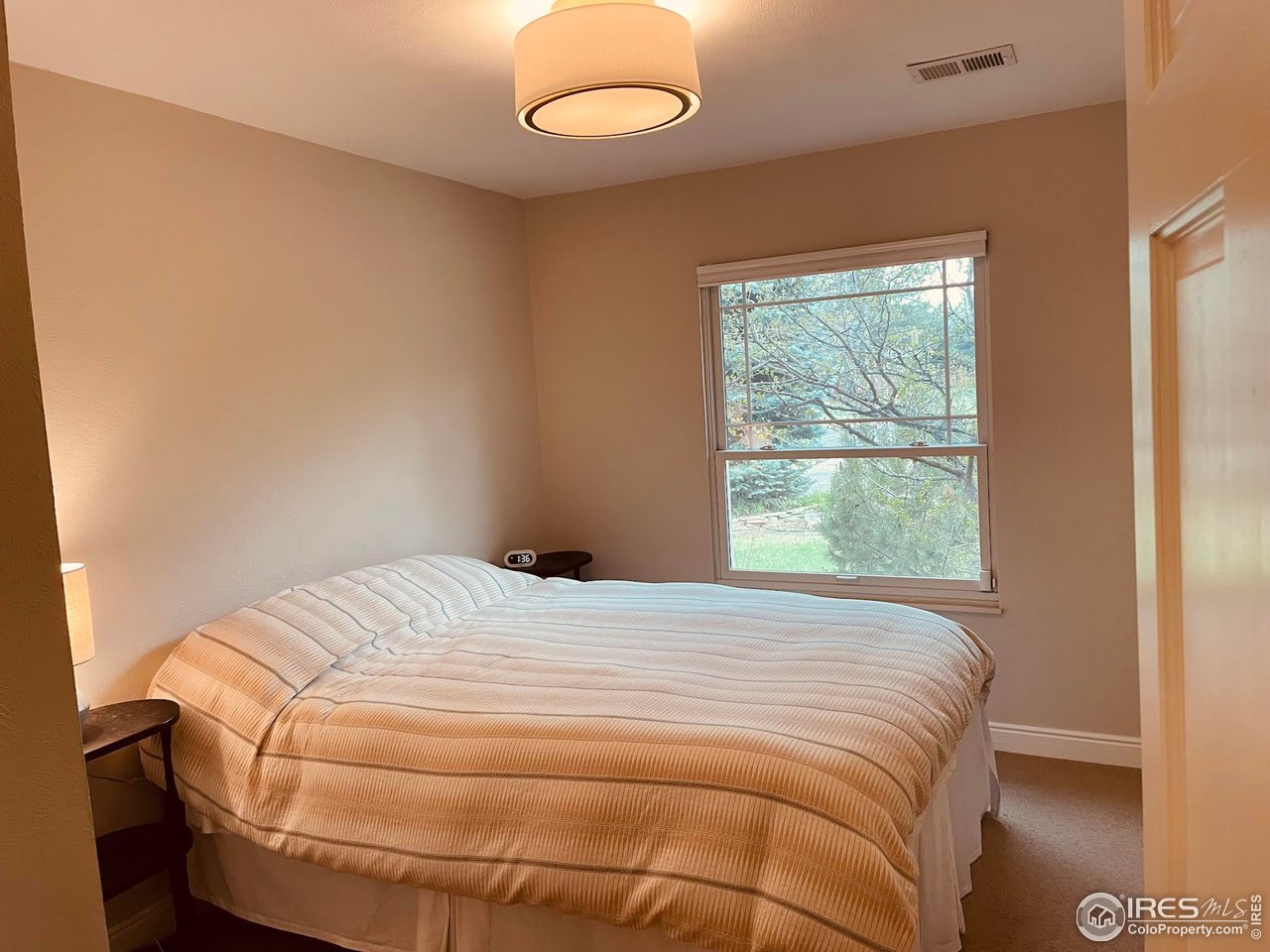 4303 30th Street Boulder, CO 80301 - Photo 31 of 37 a bedroom with a bed and a window