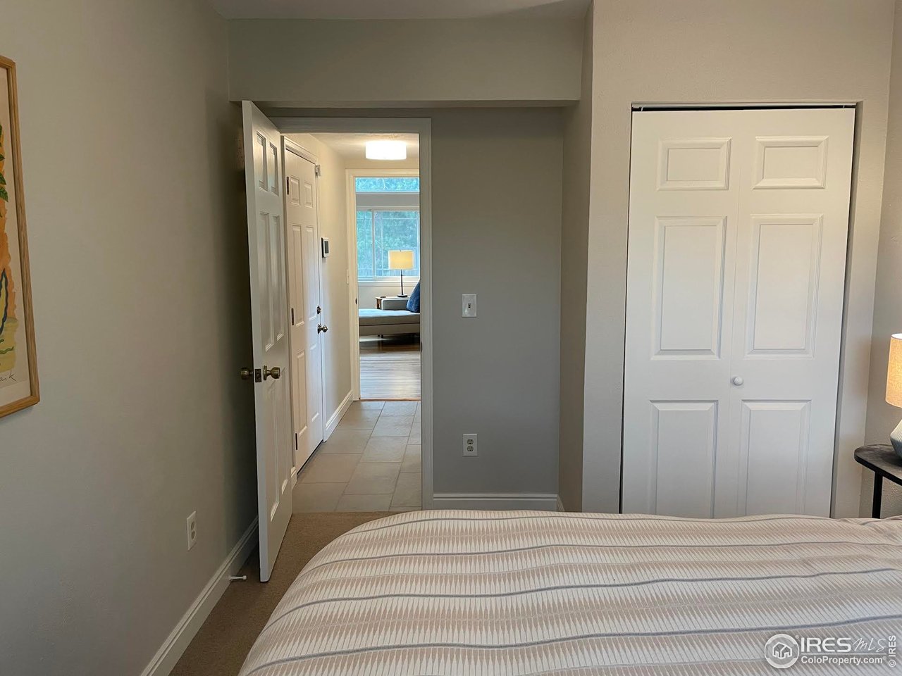 4303 30th Street Boulder, CO 80301 - Photo 32 of 37 a bedroom with a bed and a mirror