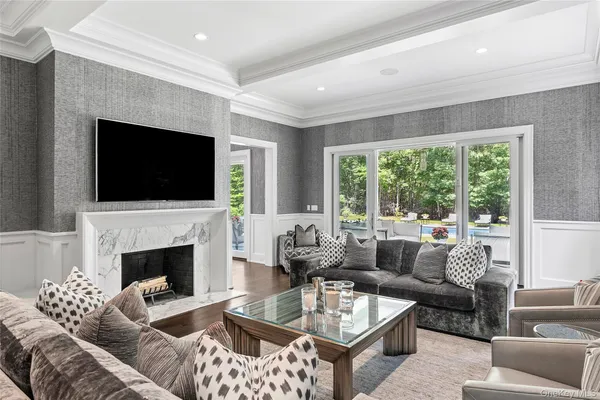 a living room with furniture a fireplace and a flat screen tv
