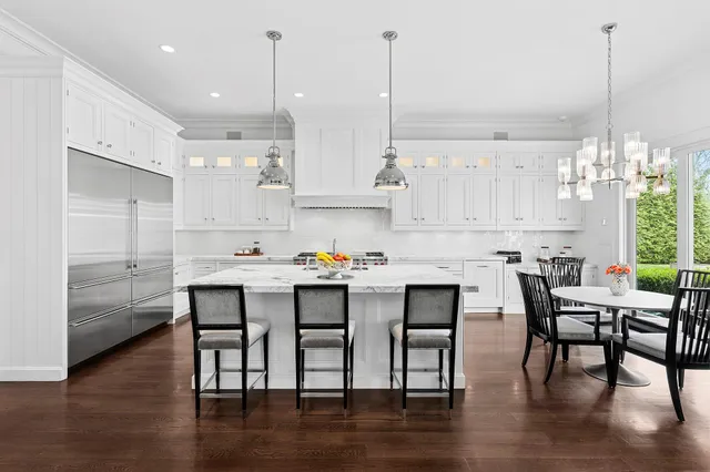 a kitchen with cabinets table and chairs