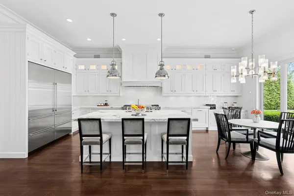 a kitchen with cabinets table and chairs