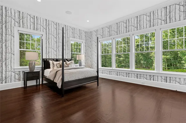 a bedroom with a bed and a large window