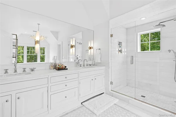 a bathroom with a shower sink and mirror