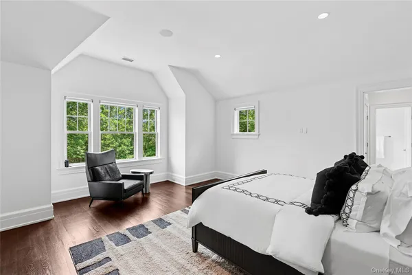 a bedroom with a bed a couch and a window