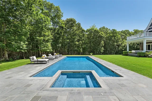 a view of yard with swimming pool and green space