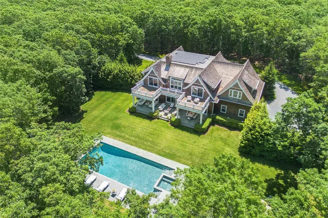 an aerial view of a house with yard patio and outdoor seating
