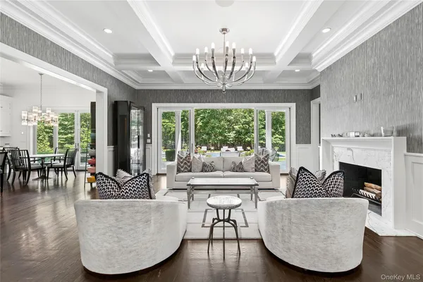 a living room with furniture and a chandelier