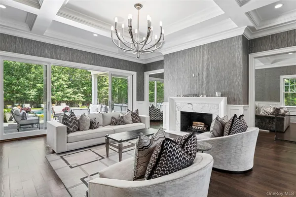 a living room with furniture a fireplace and a large window