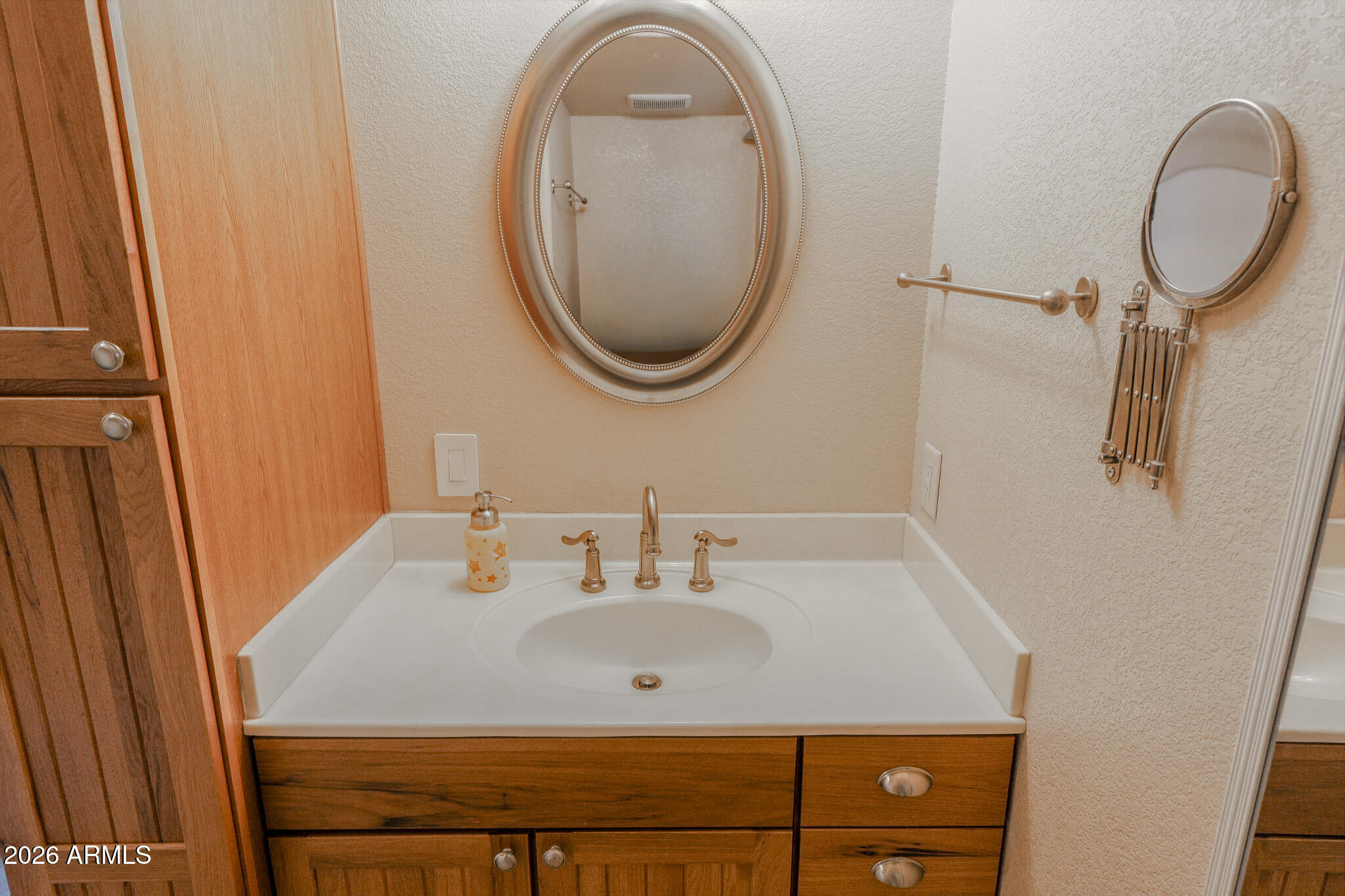 17200 West Bell Road, Unit 1806 Surprise, AZ 85374 - Photo 13 of 23 a bathroom with a sink and a mirror