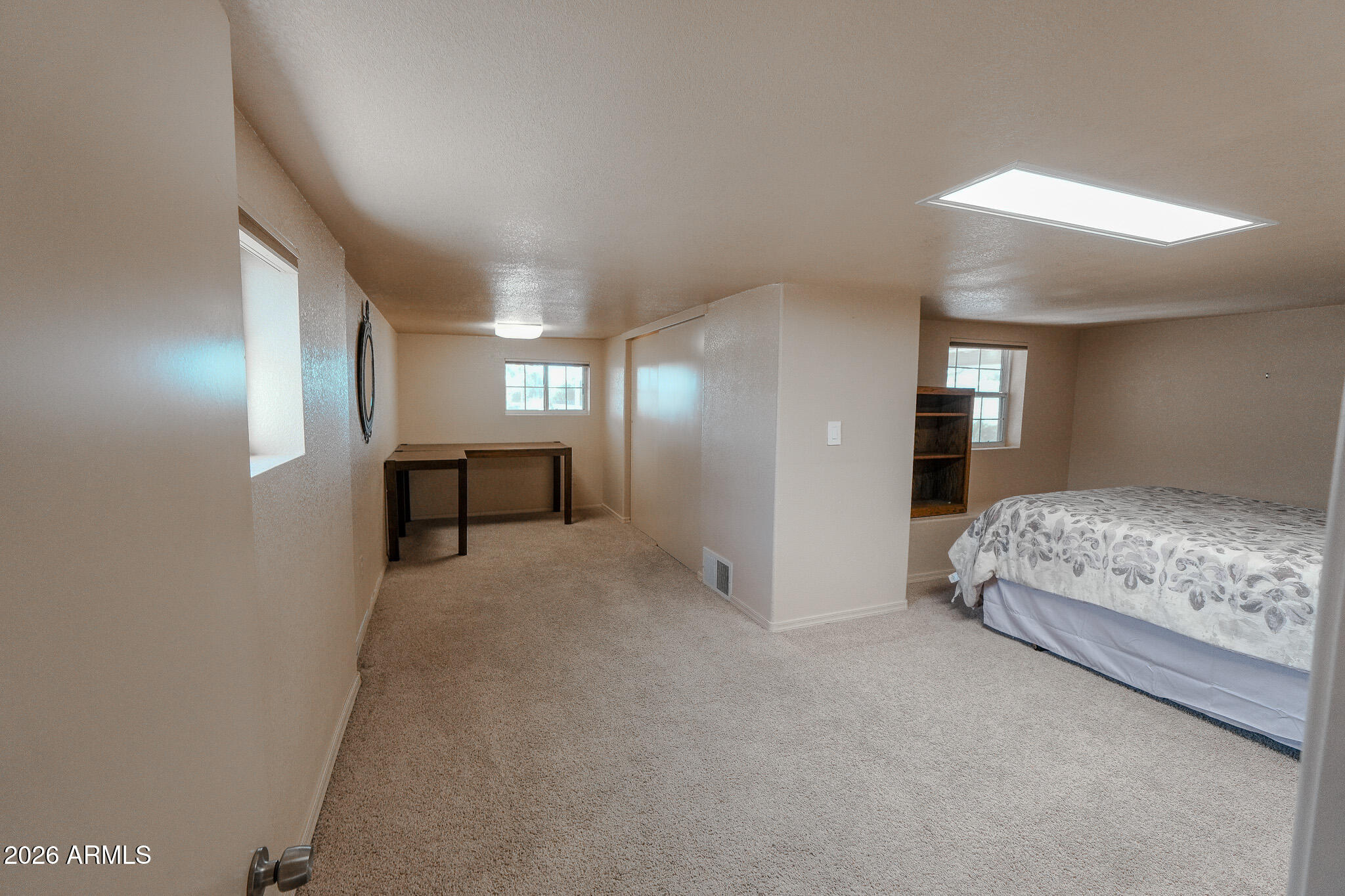 17200 West Bell Road, Unit 1806 Surprise, AZ 85374 - Photo 17 of 23 a spacious bedroom with a bed and a lamp
