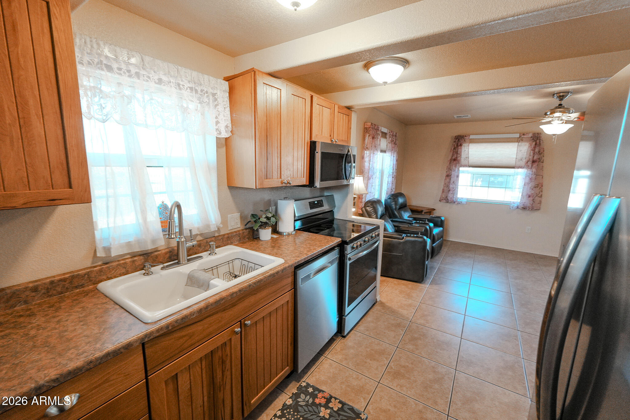 17200 West Bell Road, Unit 1806 Surprise, AZ 85374 - Photo 2 of 23 a kitchen with a sink stove and cabinets