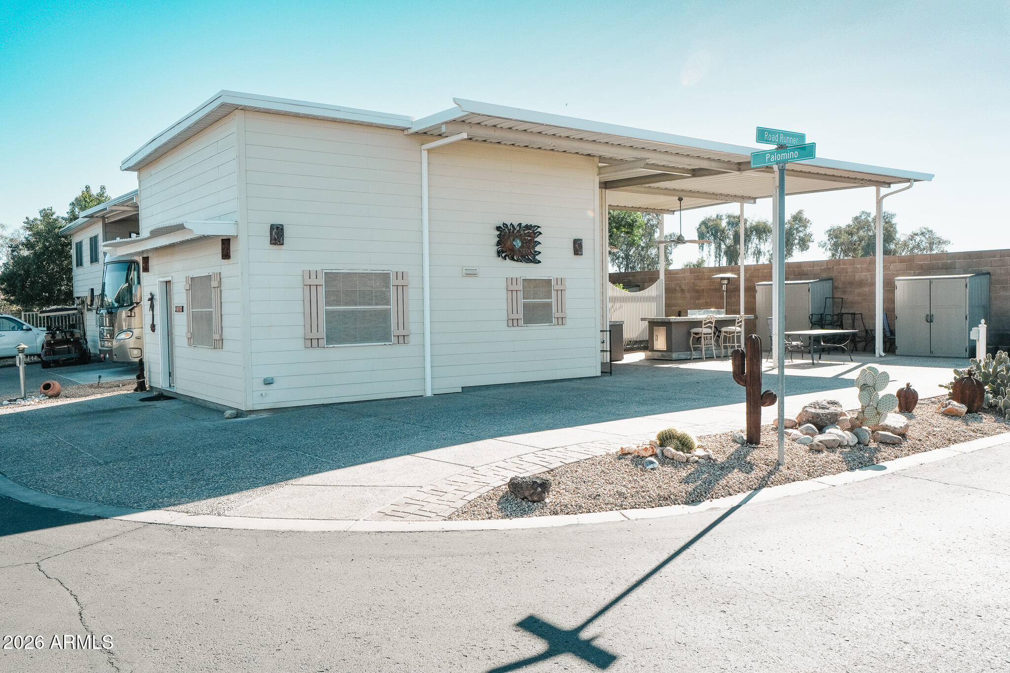 17200 West Bell Road, Unit 1806 Surprise, AZ 85374 - Photo 23 of 23 a backyard of a house with barbeque oven table and chairs