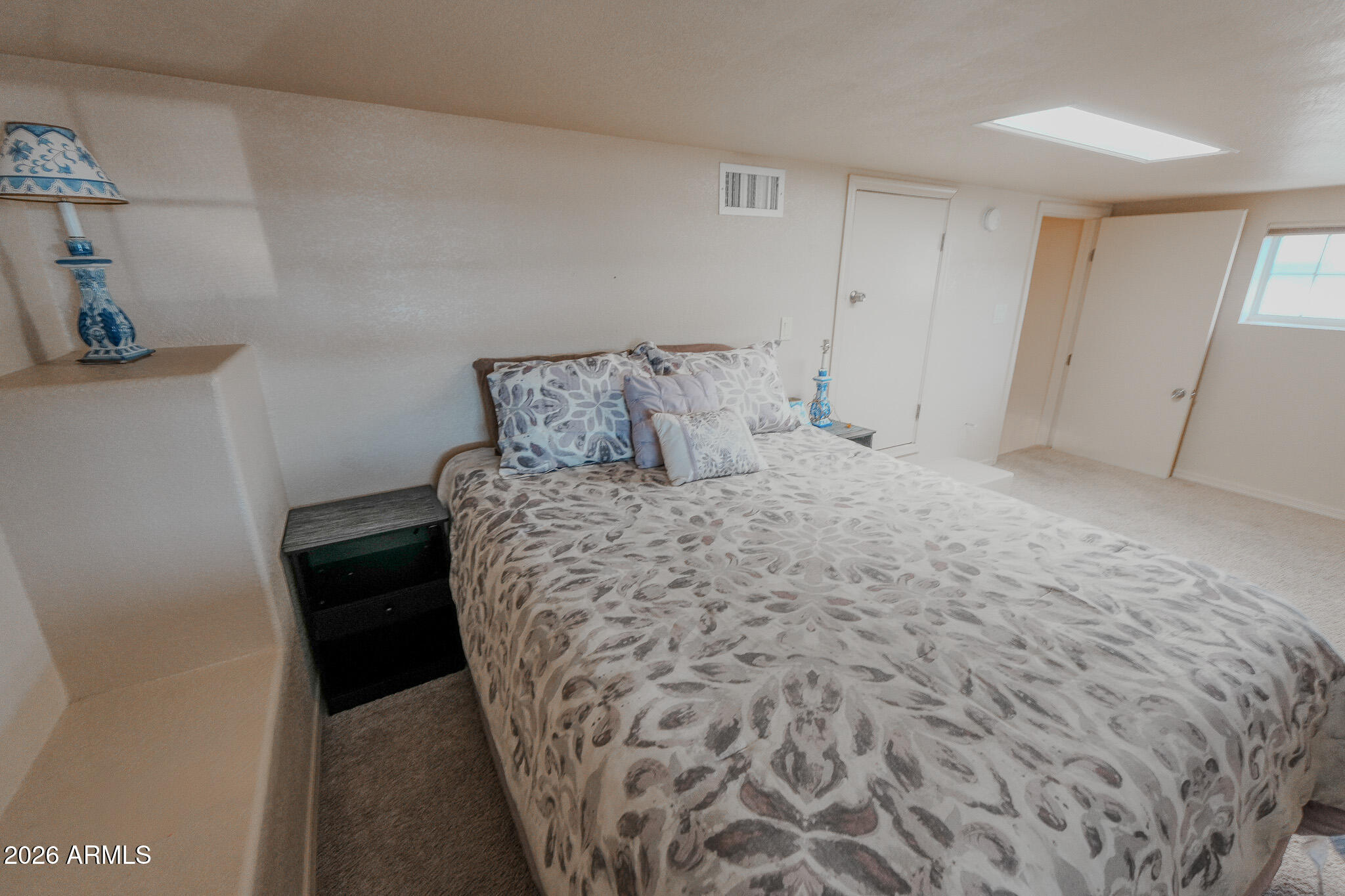 17200 West Bell Road, Unit 1806 Surprise, AZ 85374 - Photo 4 of 23 a large bed sitting in a bedroom next to a window