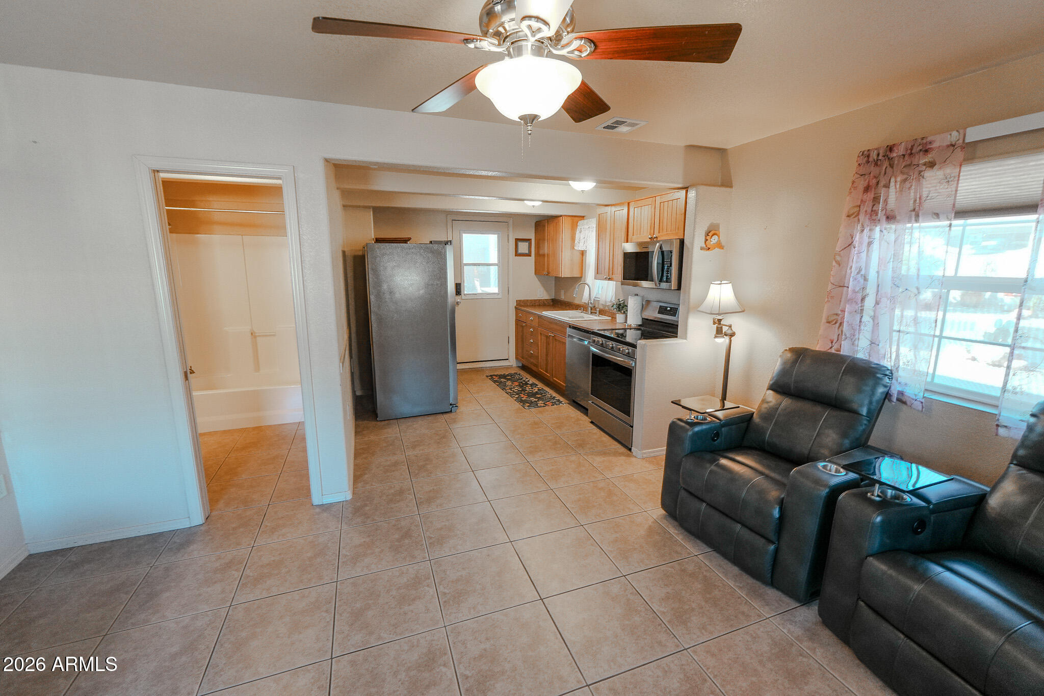 17200 West Bell Road, Unit 1806 Surprise, AZ 85374 - Photo 7 of 23 a living room with furniture and a flat screen tv