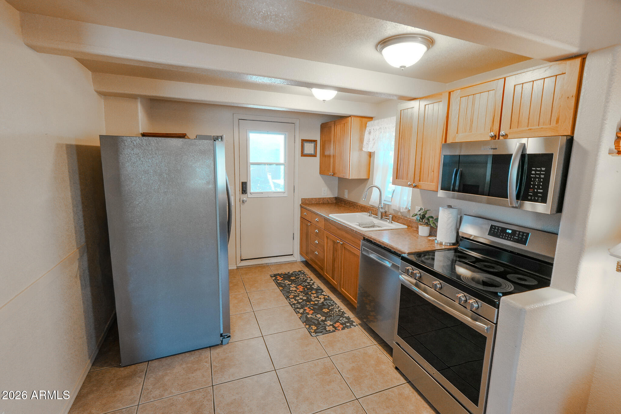 17200 West Bell Road, Unit 1806 Surprise, AZ 85374 - Photo 8 of 23 a kitchen with stainless steel appliances a refrigerator and a stove top oven