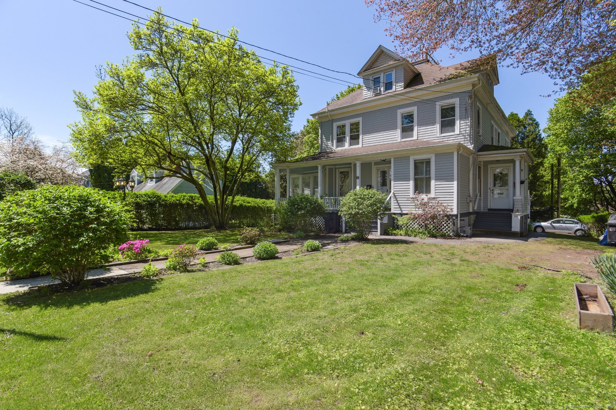 a front view of a house with a garden and sitting area
