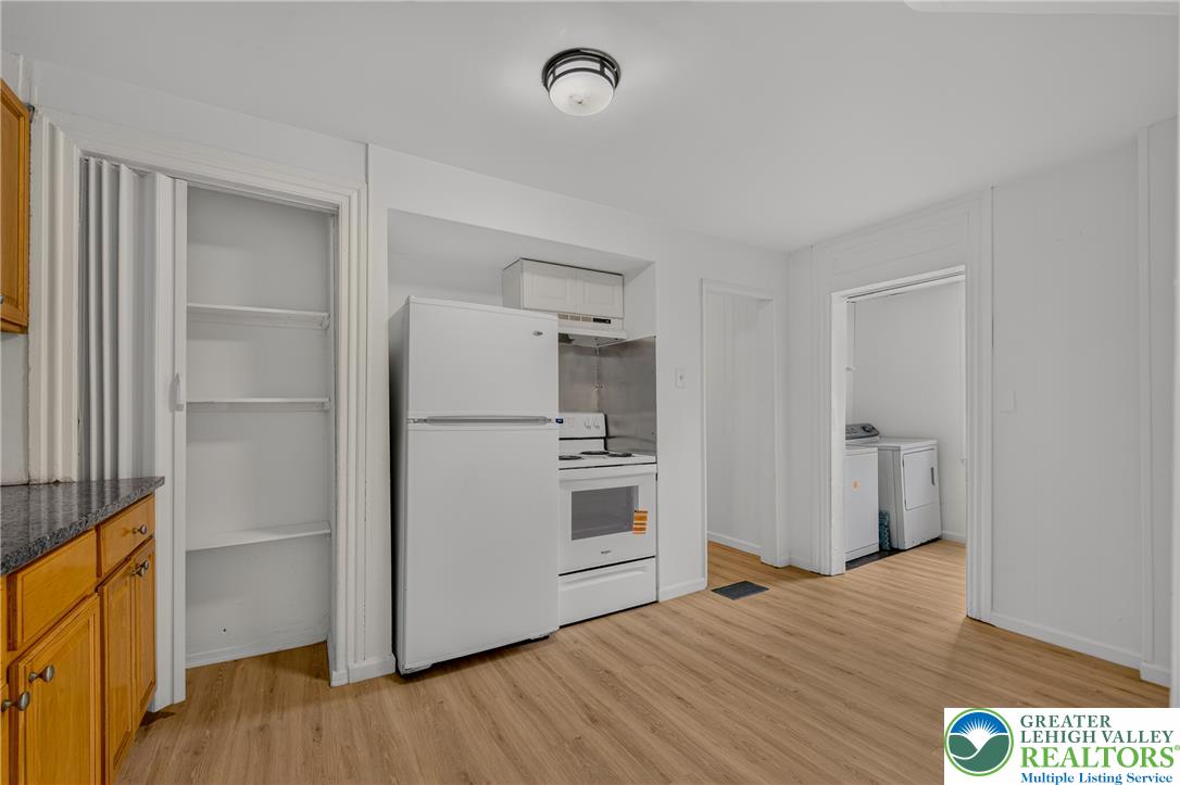 313 Main Street Slatington, PA 18080 - Photo 31 of 73 A compact kitchen boasts a full suite of appliances and wood-style flooring.