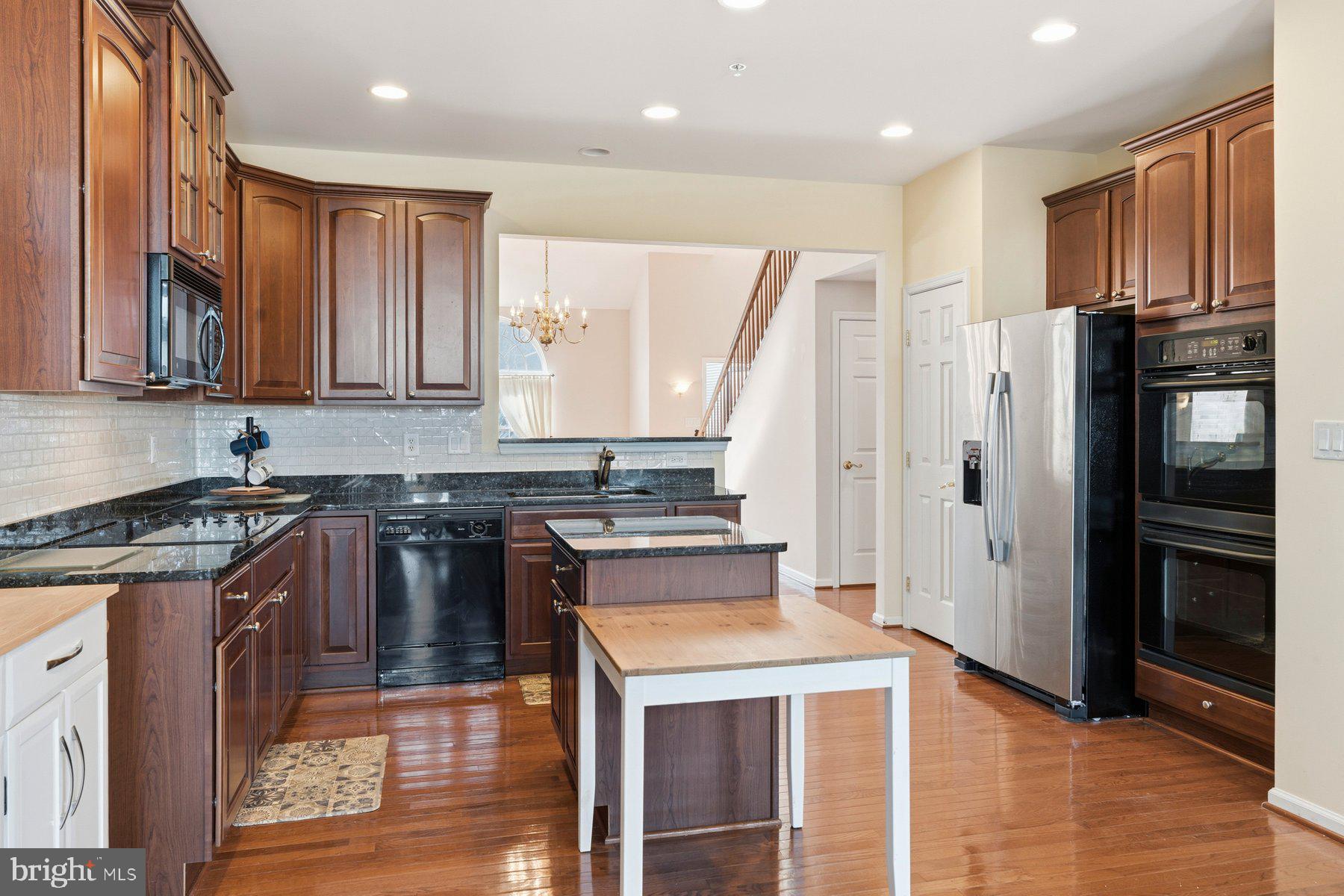 8330 Meadowsweet Road, Unit 8330 Pikesville, MD 21208 - Photo 55 of 55 a kitchen with stainless steel appliances granite countertop a stove a sink and a refrigerator