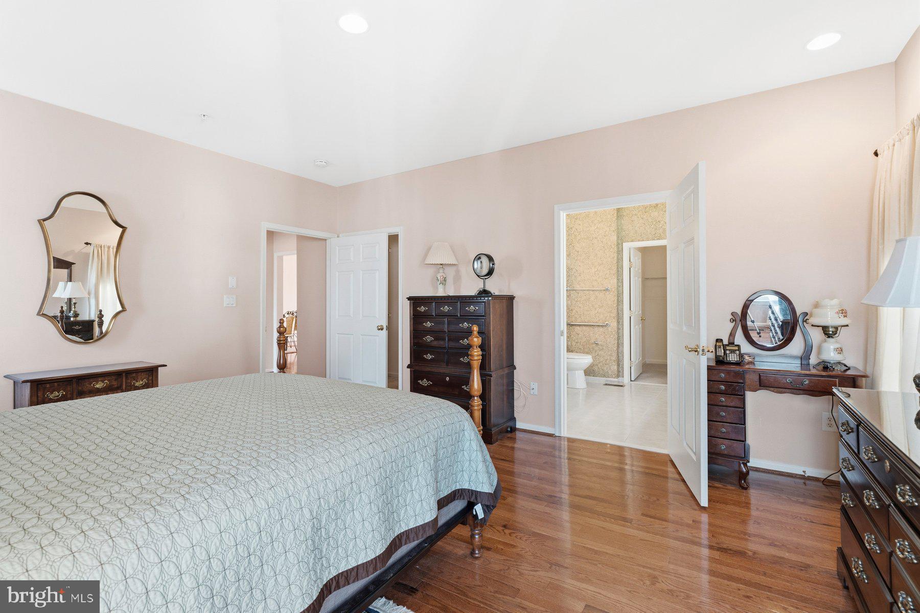 8330 Meadowsweet Road, Unit 8330 Pikesville, MD 21208 - Photo 13 of 55 a bedroom with a bed and a chandelier