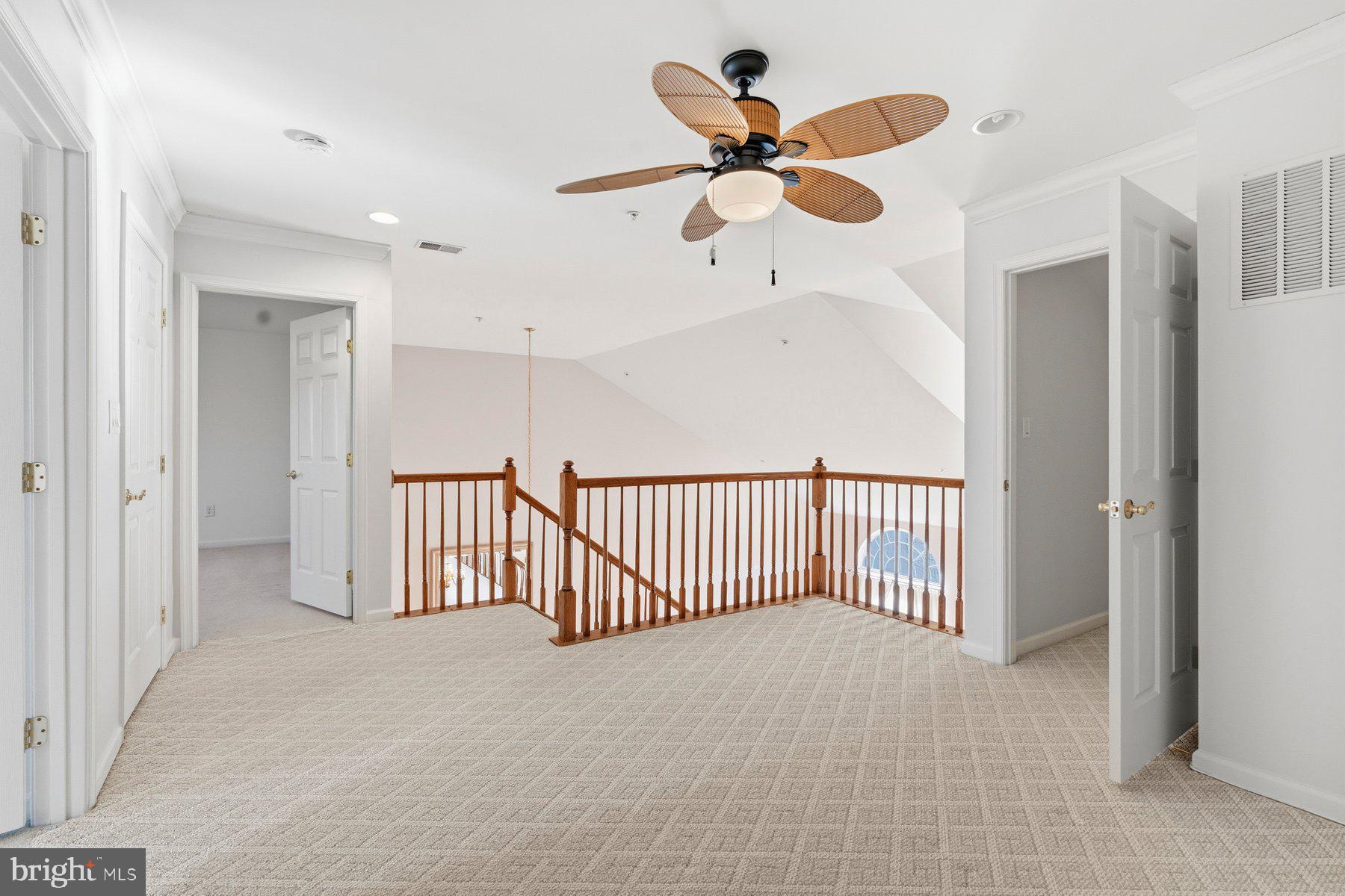 8330 Meadowsweet Road, Unit 8330 Pikesville, MD 21208 - Photo 23 of 55 a view of a hallway and a chandelier fan