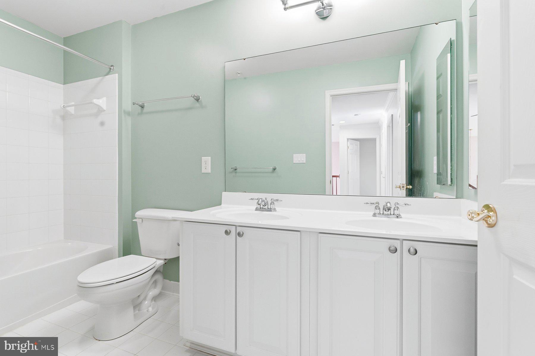 8330 Meadowsweet Road, Unit 8330 Pikesville, MD 21208 - Photo 26 of 55 a bathroom with a sink a toilet and a mirror