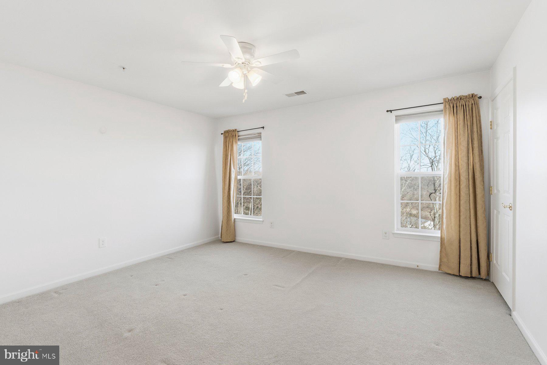 8330 Meadowsweet Road, Unit 8330 Pikesville, MD 21208 - Photo 31 of 55 a view of an empty room with a window