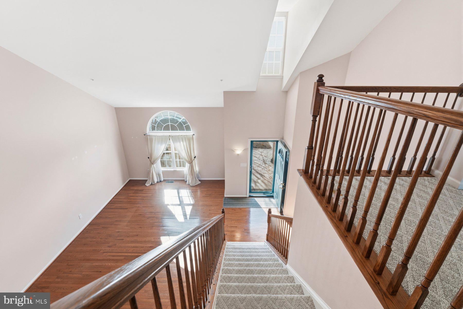 8330 Meadowsweet Road, Unit 8330 Pikesville, MD 21208 - Photo 3 of 55 a view of a hallway with wooden floor and staircase