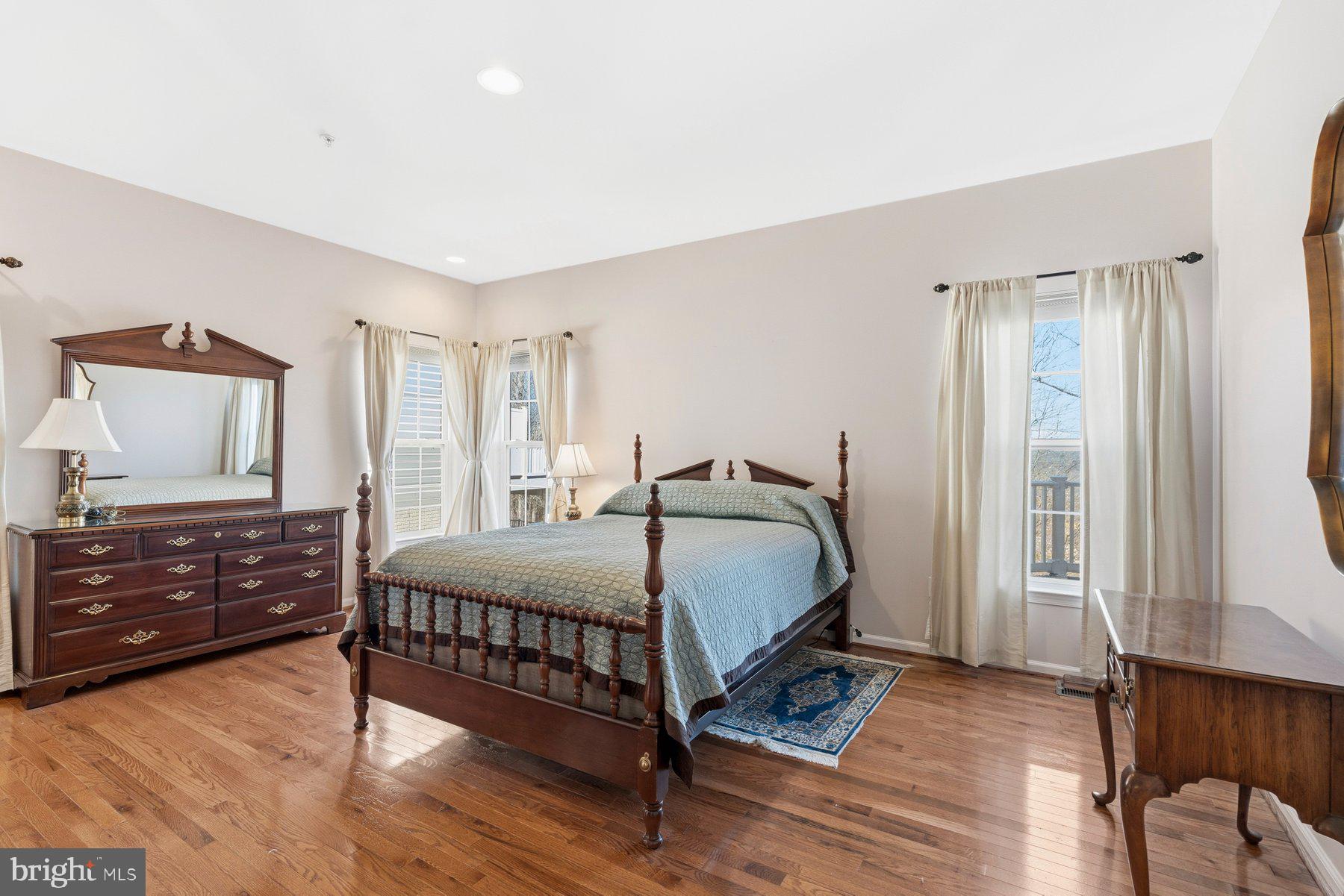 8330 Meadowsweet Road, Unit 8330 Pikesville, MD 21208 - Photo 5 of 55 a bedroom with a bed and wooden floor