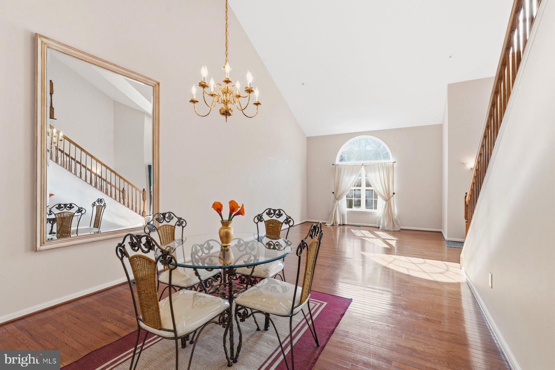 8330 Meadowsweet Road, Unit 8330 Pikesville, MD 21208 - Photo 6 of 55 a view of a dining room with furniture wooden floor and a chandelier