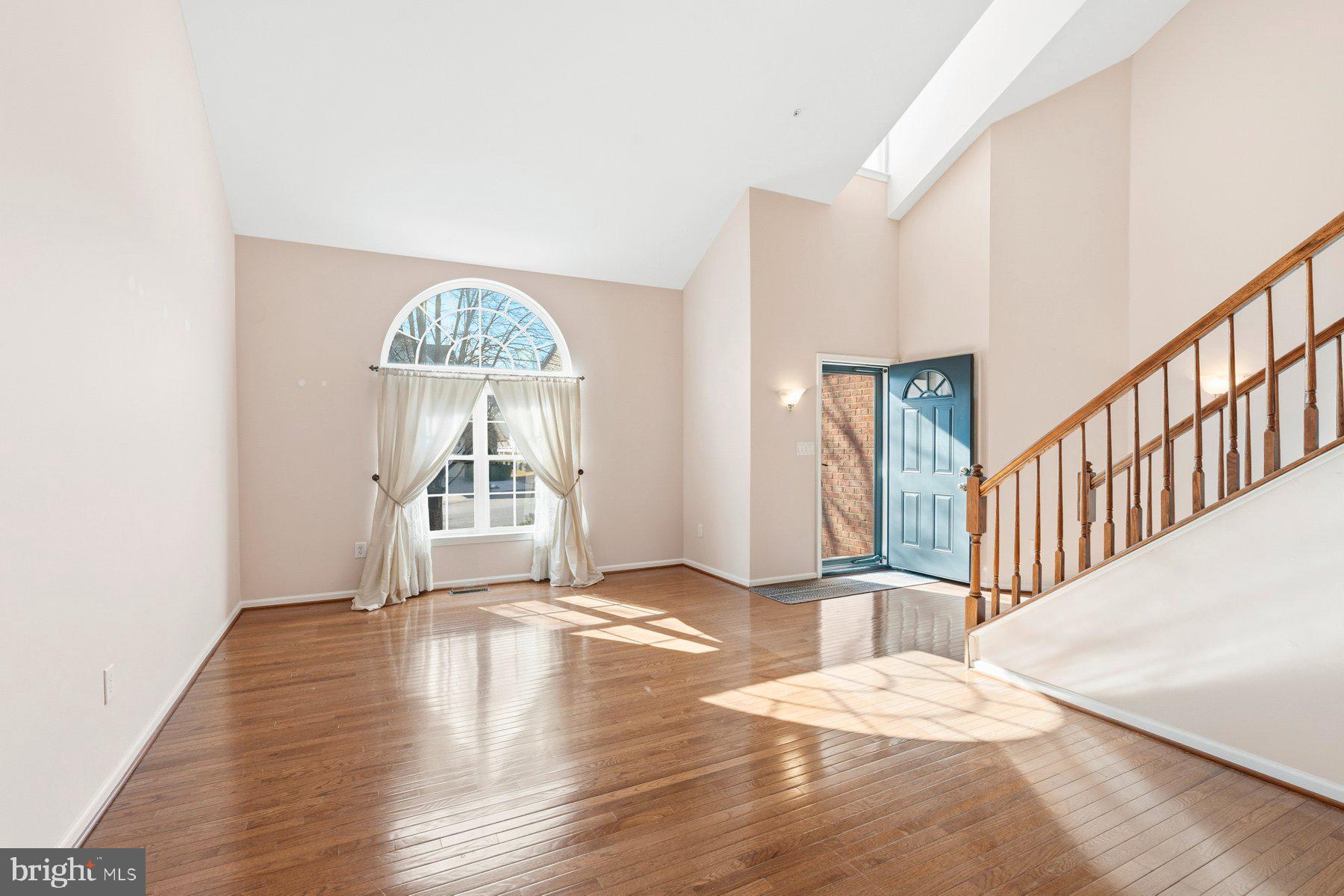8330 Meadowsweet Road, Unit 8330 Pikesville, MD 21208 - Photo 7 of 55 a view of an empty room with wooden floor and a window