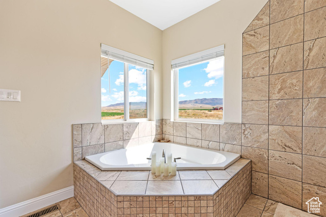 19502 South Olson Road Downey, ID 83234 - Photo 22 of 64 Main bathroom with a bath, a mountain view, and light tile patterned flooring