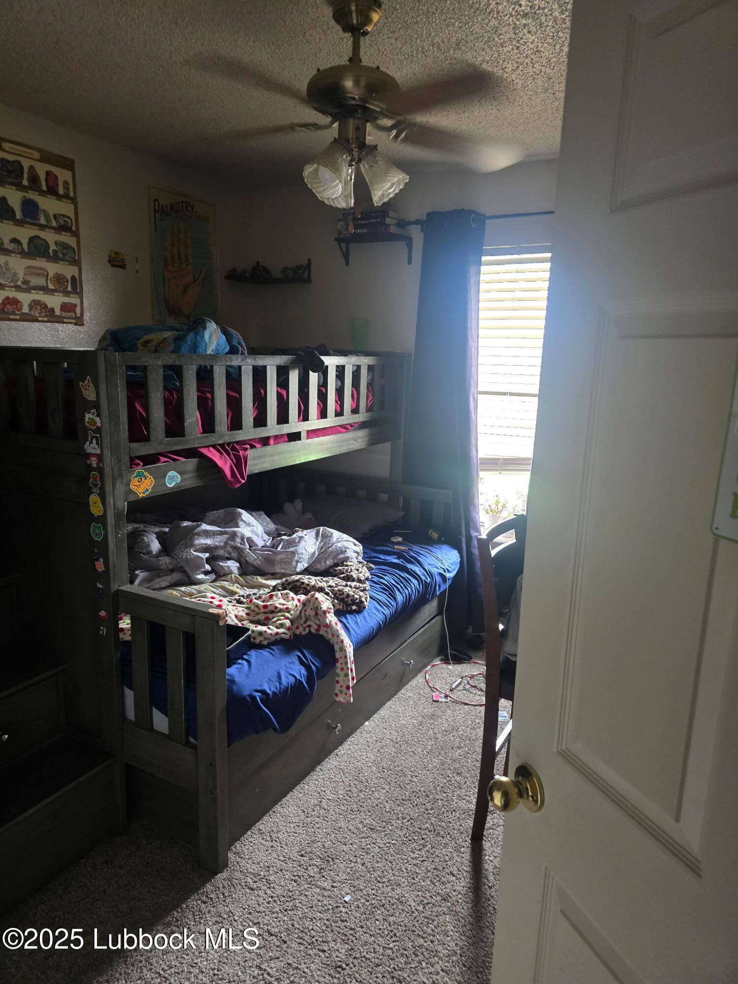 6004 68th Street Lubbock, TX 79424 - Photo 11 of 16 a bed sitting in a bedroom next to a window