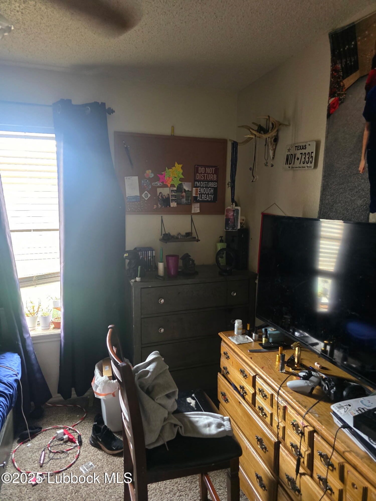 6004 68th Street Lubbock, TX 79424 - Photo 12 of 16 a room with furniture a lamp and a window