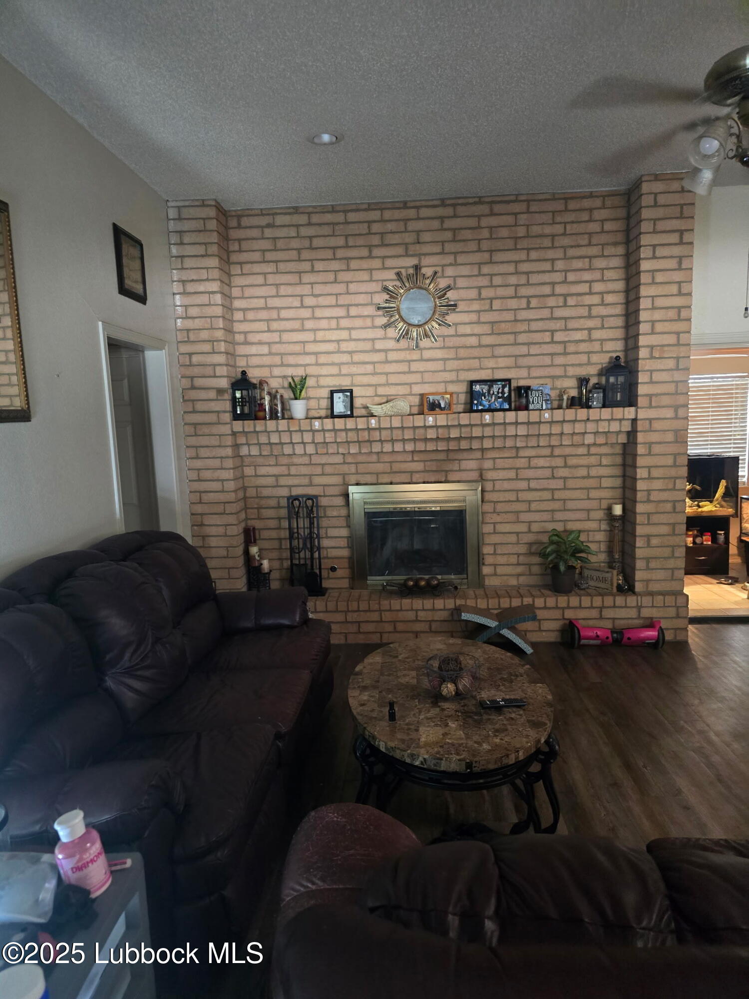 6004 68th Street Lubbock, TX 79424 - Photo 3 of 16 a living room with furniture and a fireplace