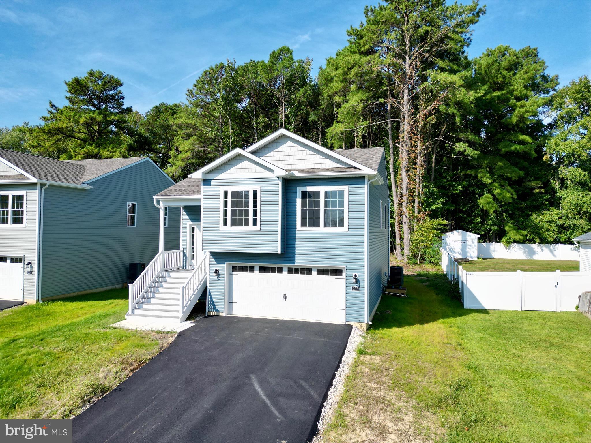 222 Long Point Road Stevensville, MD 21666 - Photo 1 of 44 a front view of a house with a yard and garage