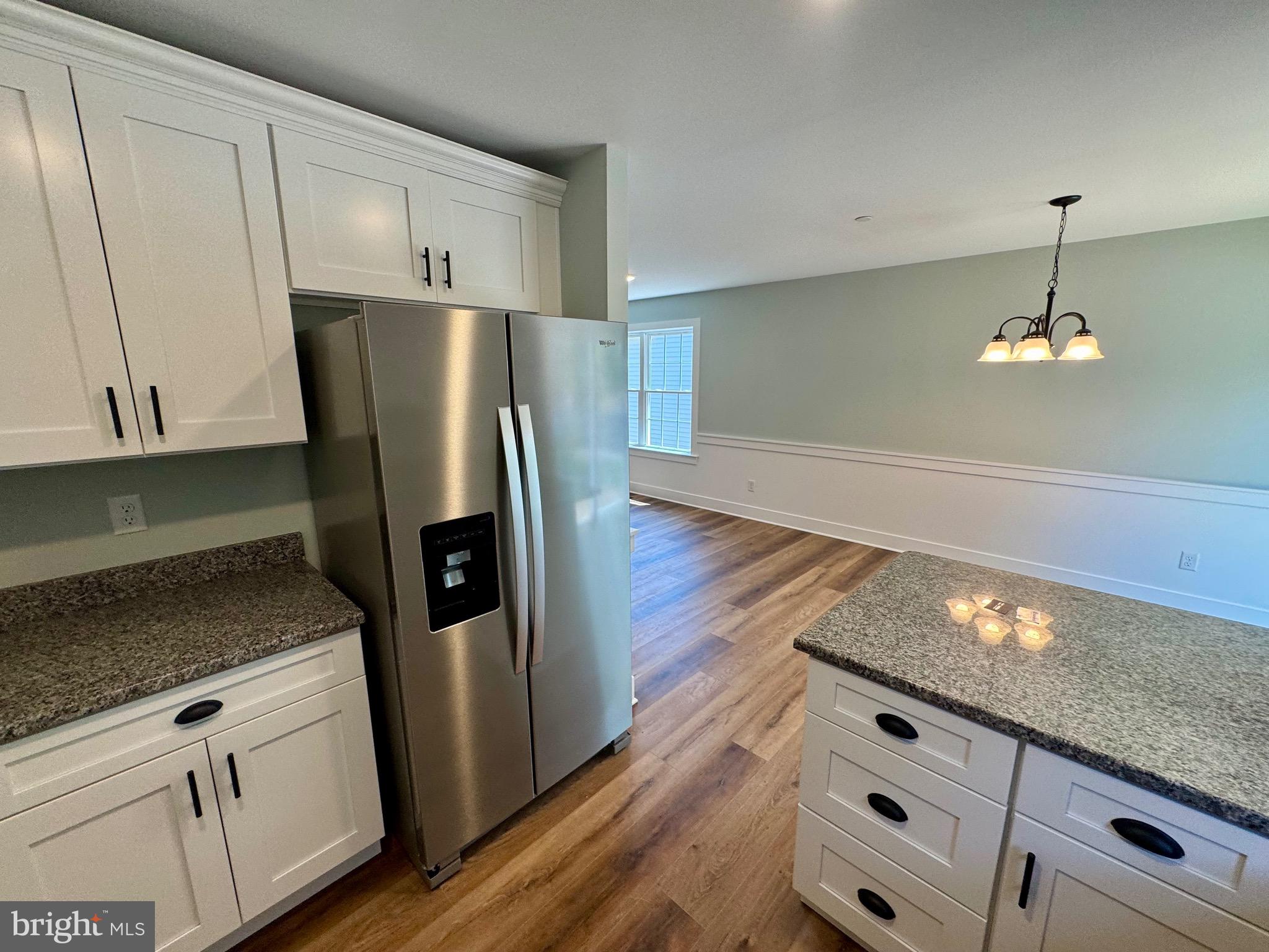 222 Long Point Road Stevensville, MD 21666 - Photo 12 of 44 a kitchen with granite countertop stainless steel appliances a counter space and cabinets