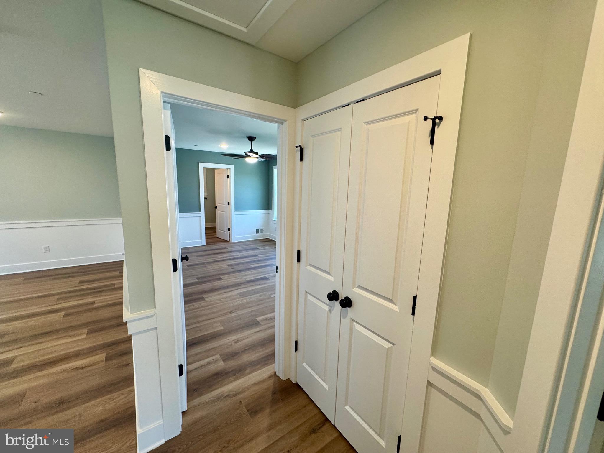 222 Long Point Road Stevensville, MD 21666 - Photo 15 of 44 a view of a hallway with wooden floor and staircase