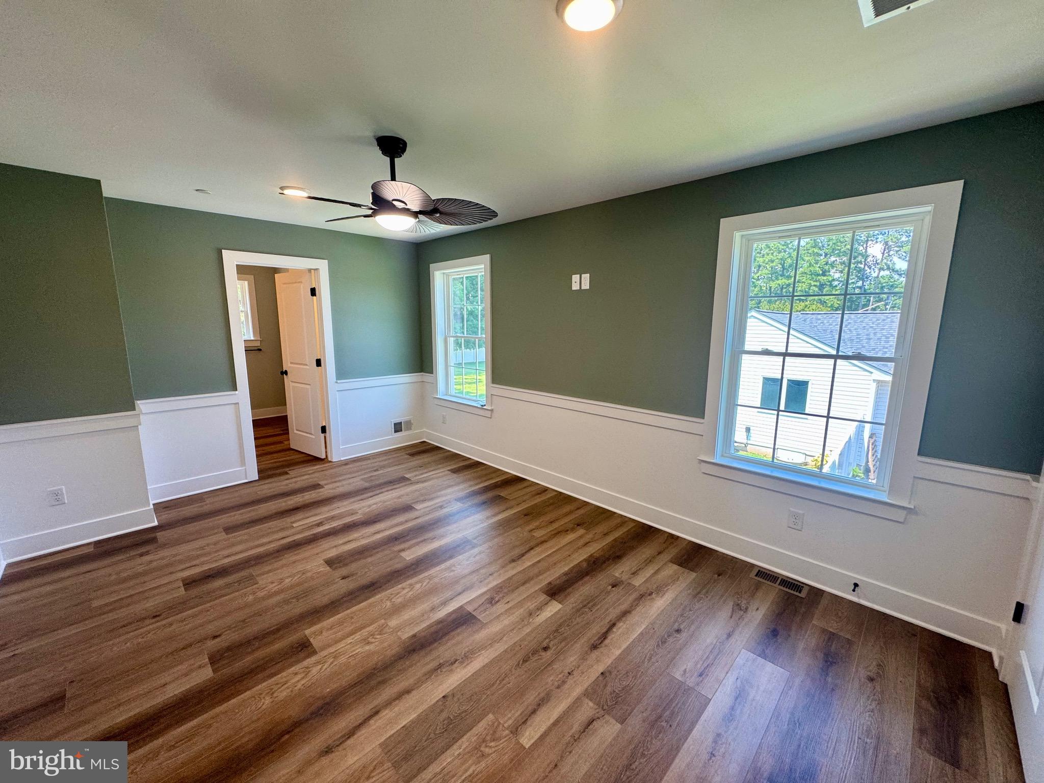 222 Long Point Road Stevensville, MD 21666 - Photo 16 of 44 wooden floor in an empty room with a window