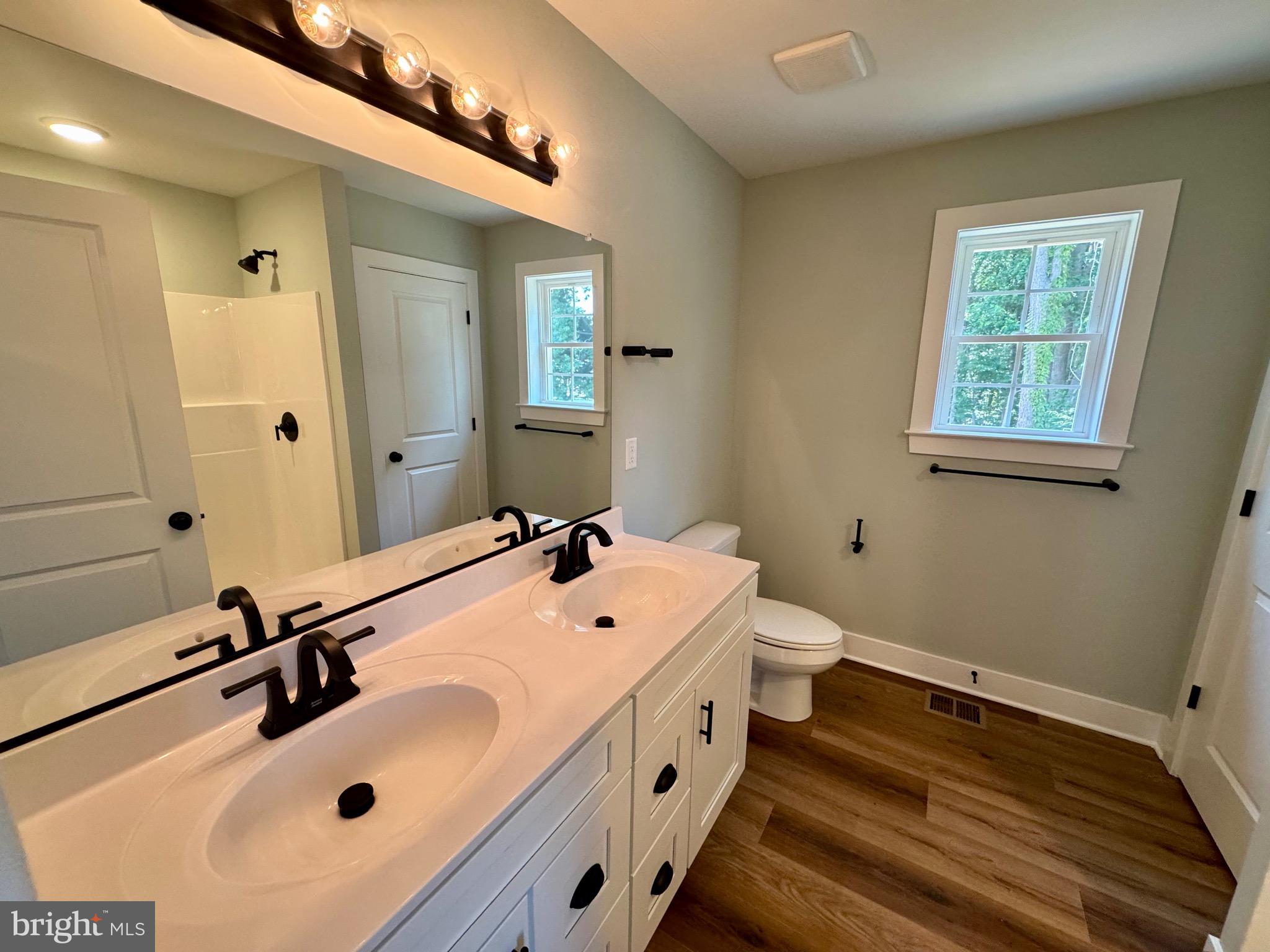 222 Long Point Road Stevensville, MD 21666 - Photo 18 of 44 a bathroom with a double vanity sink and mirror