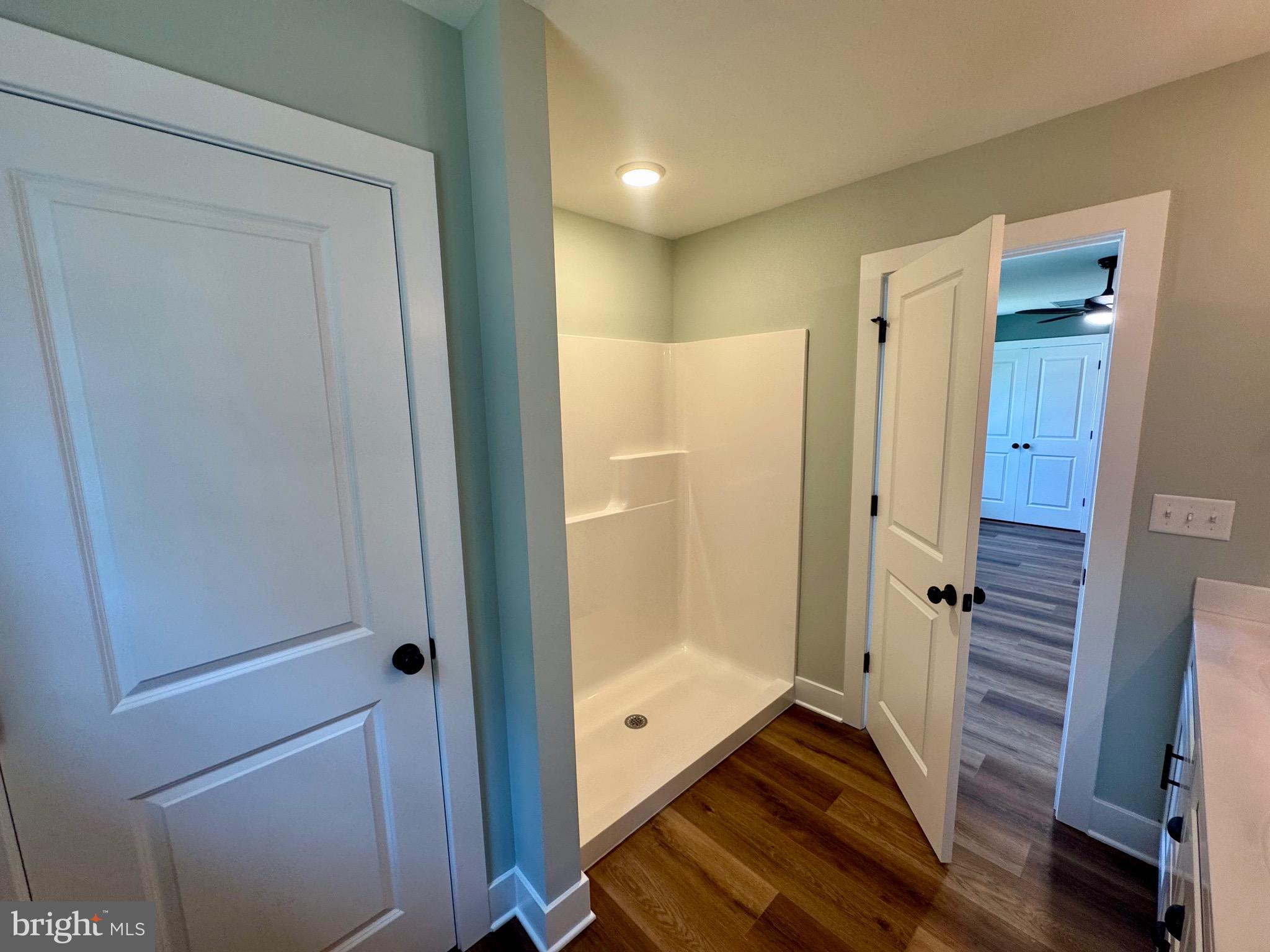 222 Long Point Road Stevensville, MD 21666 - Photo 19 of 44 a bathroom with a shower and a glass door